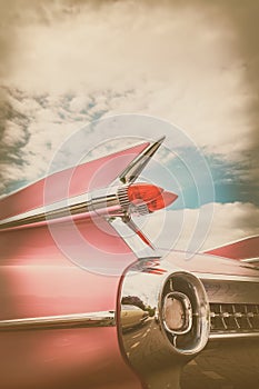 Rear end of a pink classic car