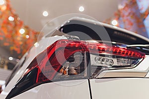 Rear light of a modern car close-up, white body.