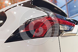 Rear light of a modern car close-up, white body.