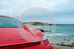 Rear light of a red Porsche Cayman 2.7 sport car, parked in fr