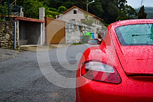 Rear light of a red Porsche Cayman 2.7 sport car, parked in a