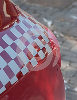 Rear light of a red sports car with a checkered flag decoration