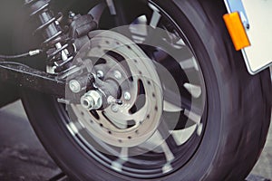 Rear motorcycle brake disc in motion, the wheel rotates