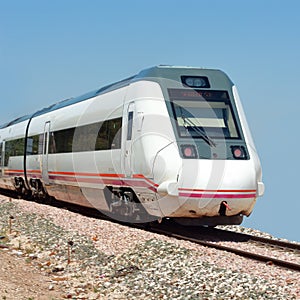 Rear of moving train on blue sky