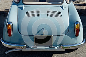 Rear of an old german classic car . Particular view of rear lights and shiny chrome bumper