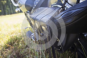 Rear part of motorcycle. Black leather bag