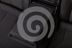 rear passenger Armrest is upholstered in black fabric trim