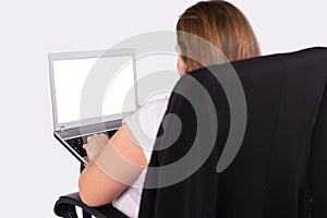 Rear photo of a large woman with a portable laptop. White screen. Work online. Studio white background.