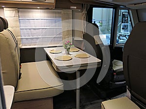 Rear seats and arranged dining table in modern german camper van Knaus Live I650 MEG