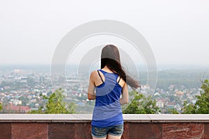 Rear shot of a young girl looking at the horizon