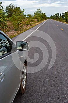 Rear side perspective view of car on road countryside