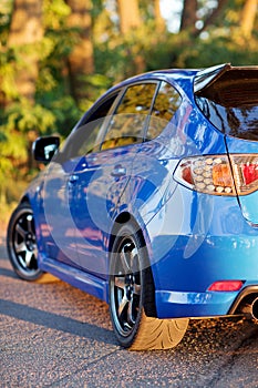 Rear side view of blue sport car