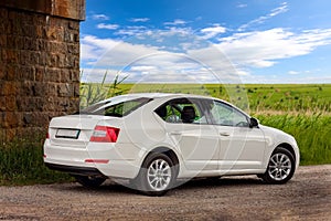 Rear-side view of a car on nature background