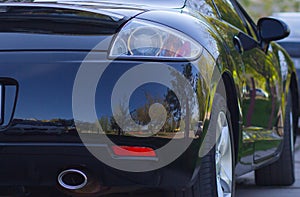 Rear-side view of a luxury car with natural reflection nature