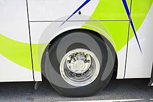 Rear side view of a modern bus for tourists on an asphalt road.