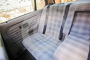 Rear textile seats wit armrest in an old retro car