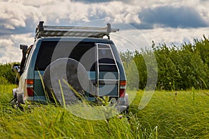 Rear view of a 4x4 SUV in the wild. The concept of travel and adventure