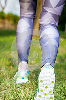 Rear view of active woman running sport shoes