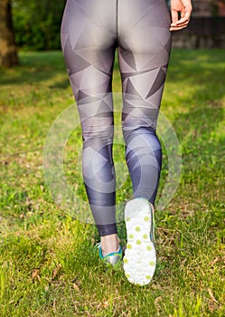 Rear view of active woman running sport shoes