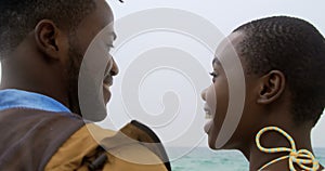 Rear view of African american couple standing together o the beach 4k