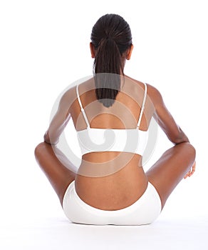 Rear view african american woman sits cross legged