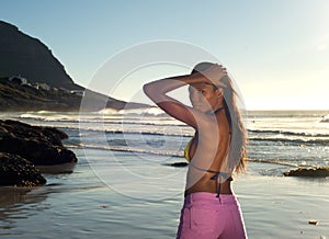 Rear view african fashion woman posing at the beach