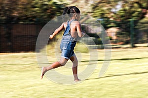 Rear view of african kid running.
