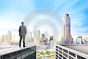 Rear view of asian businessman standing on the rooftop