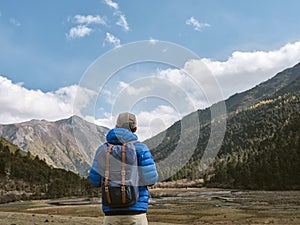 Rear view of asian man looking at view while traveling