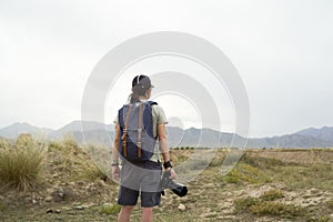 Rear view of asian photographer looking at view