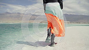 Rear view of asian woman walking on beach of salt lake