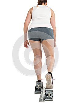 Rear view of athlete woman running from starting blocks