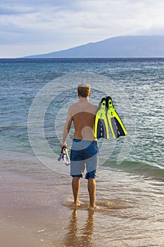 Rear view of an attractive man going snorkeling in Hawaii