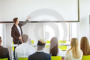 Rear view of Audience in the conference hall or seminar meeting which have Speakers on the stage, business and education about