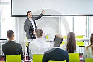 Rear view of Audience in the conference hall or seminar meeting which have Speakers on the stage, business and education about