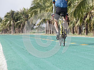 Rear view of bicycle man riding on green track