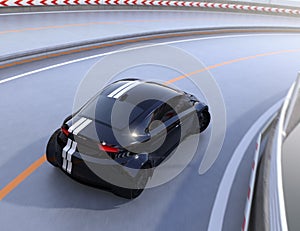 Rear view of black electric sports car driving on the highway