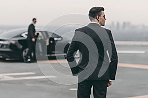 rear view of bodyguard in suit photo