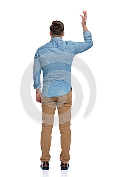 Rear view of a bothered casual man arguing and gesturing photo