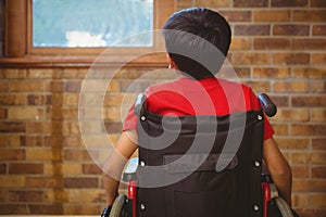 Rear view of boy sitting in wheelchair