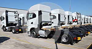 Rear view of brand new Iveco semi trucks showing outside the local dealership of the italian automotive company