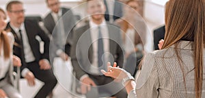 rear view .business woman holds a working meeting with the business team