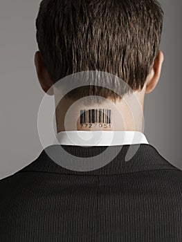 Rear View Of Businessman With Bar Code Tattoo On Neck