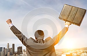 Rear view of Businessman Celebrating with lens flare