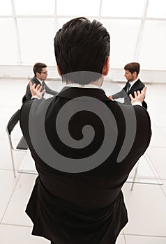 Rear view.businessman holds a working meeting.