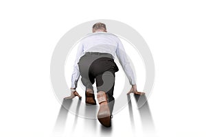 Rear view of a businessman in ready to start running position
