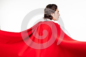 Rear view of businessman in red cout superhero on white background