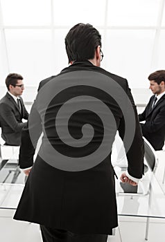 Rear view.businessman standing in the conference room