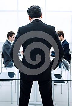 Rear view.businessman standing in the conference room