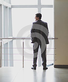 Rear view. businessman standing in the lobby of a modern office